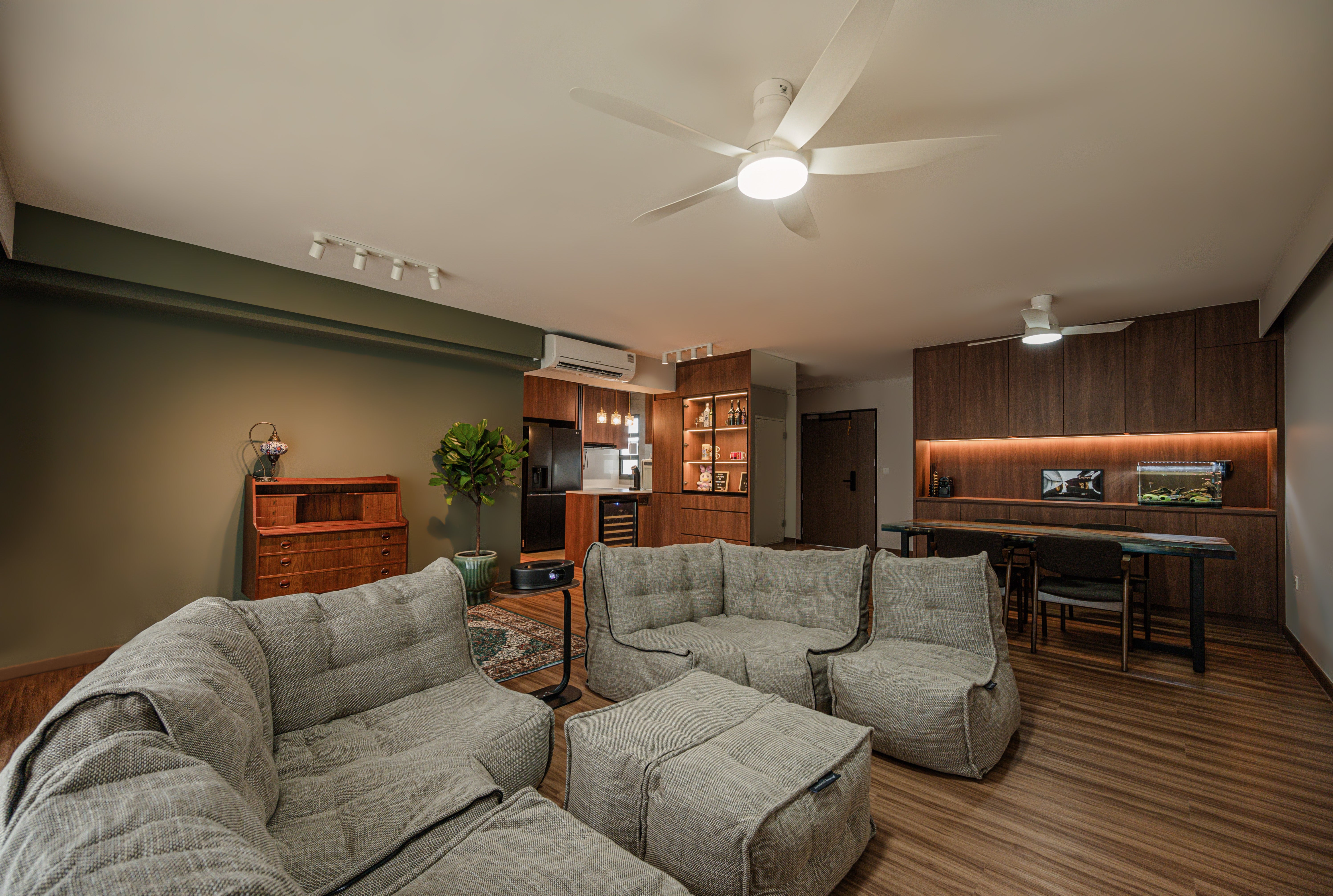Living room with beige Modular bean bag sofa, wooden floor, and ceiling fan.