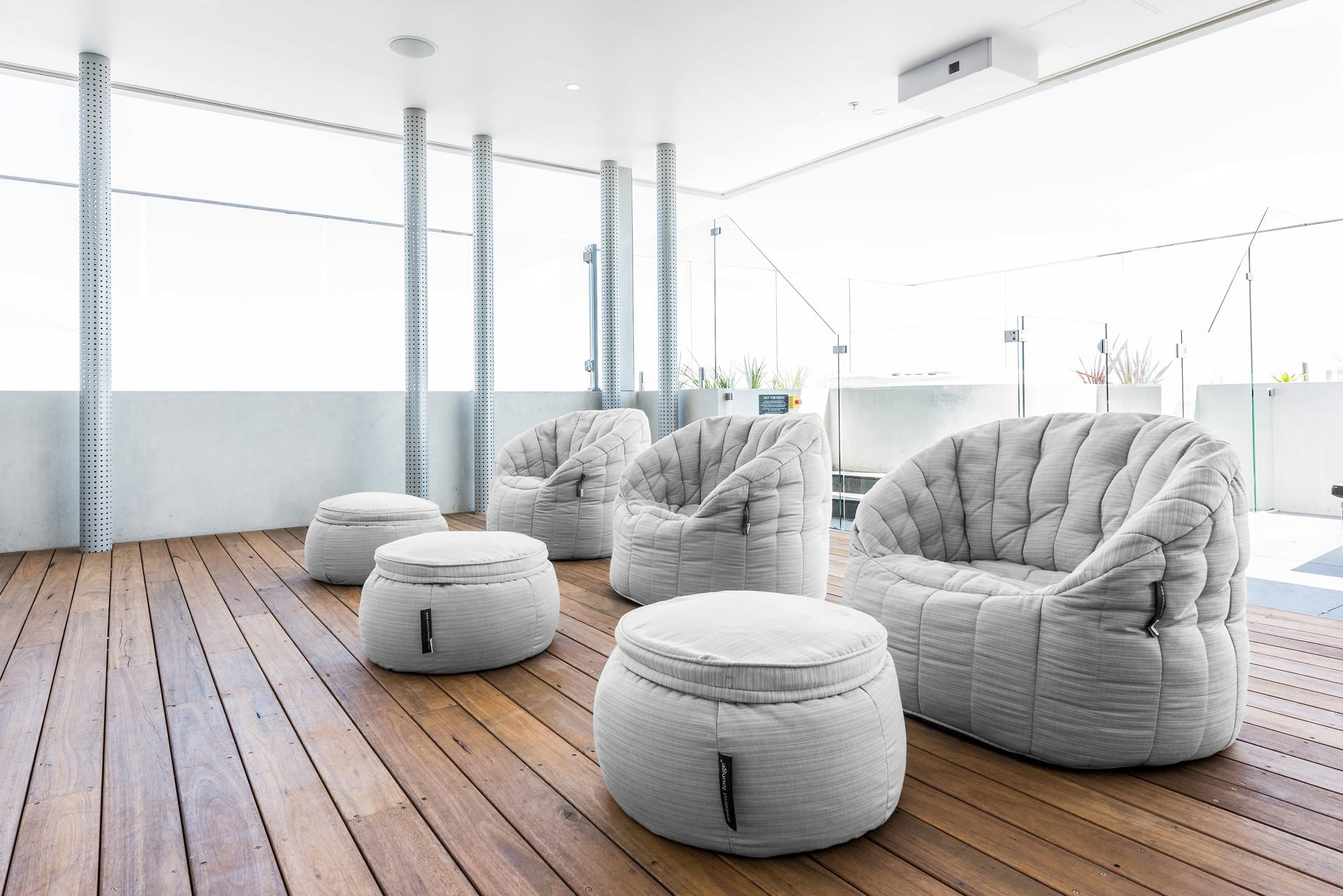 Grey Butterfly Sofa and Wing Ottoman bean bags on a rooftop deck.