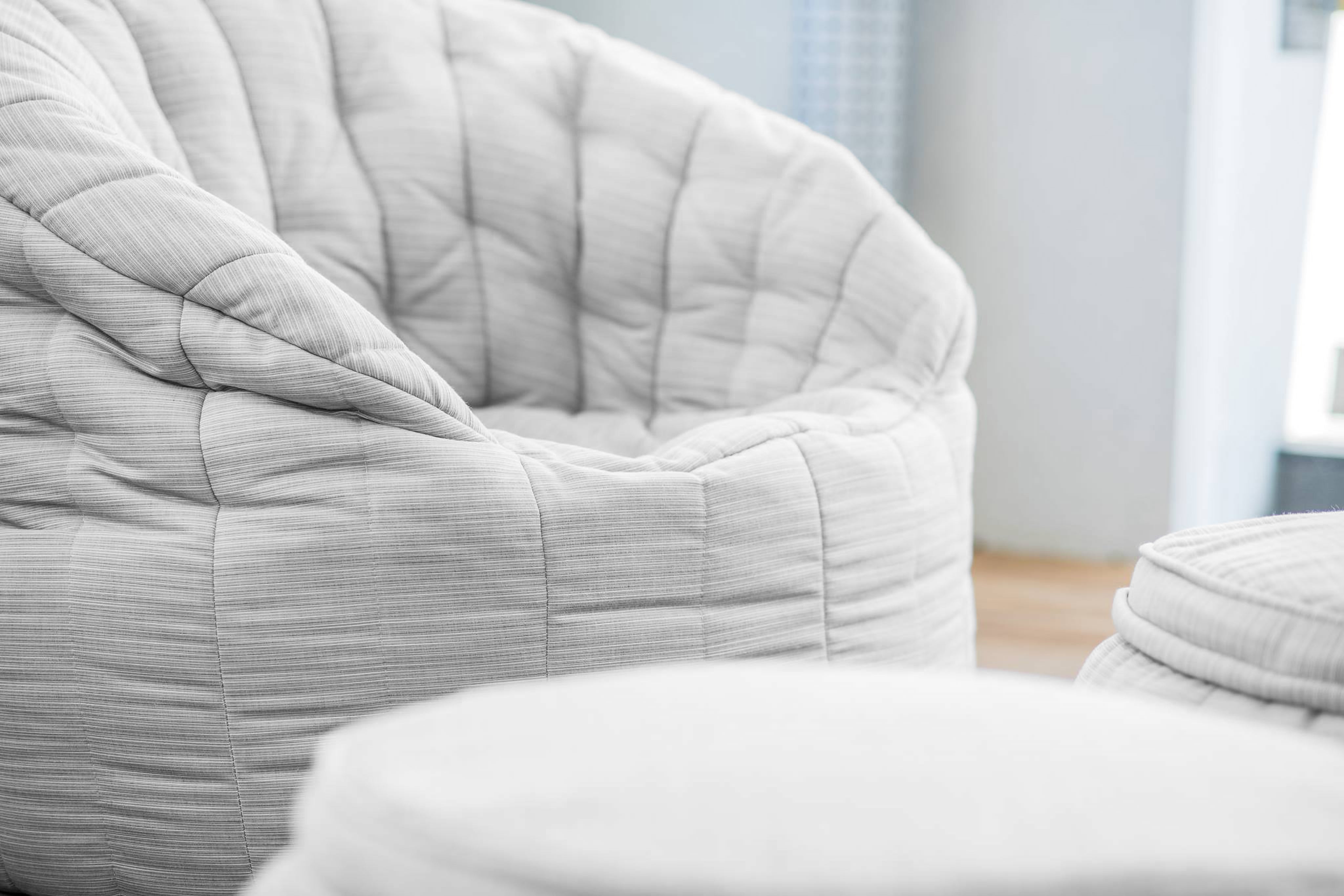 Close-up of grey Butterfly Sofa and Wing Ottoman bean bags.
