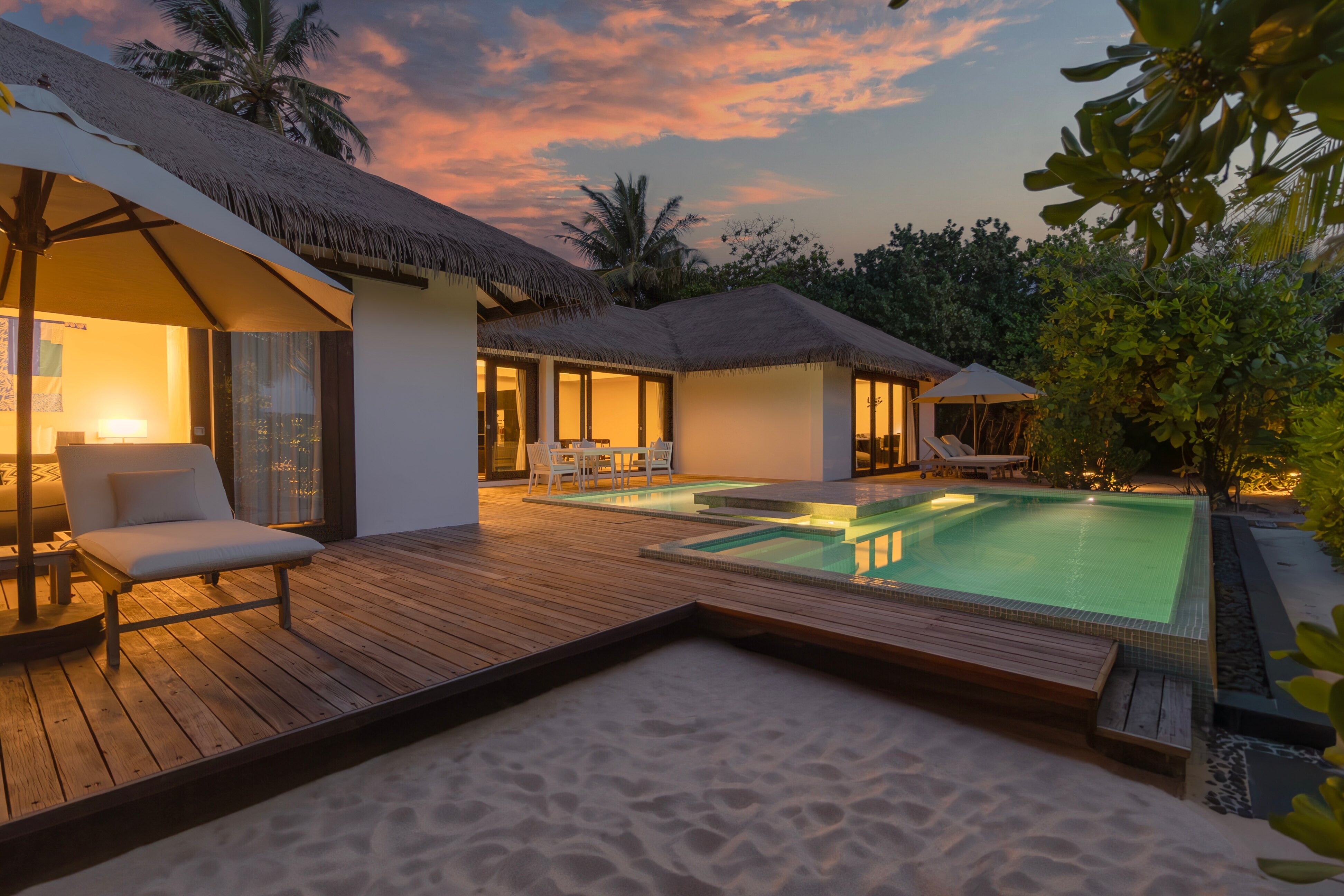 Evening view of 2-Bedroom Beachfront Pool Villa at Noku Maldives Resort.